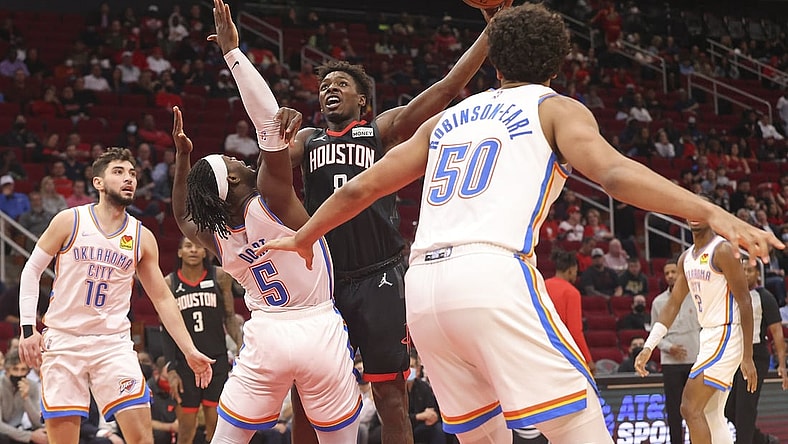 Nov 29, 2021; Houston, Texas, USA; Houston Rockets forward Jae'Sean Tate (8) drives against Oklahoma City Thunder forward Luguentz Dort (5) in the second quarter at Toyota Center. Mandatory Credit: Thomas Shea-USA TODAY Sports