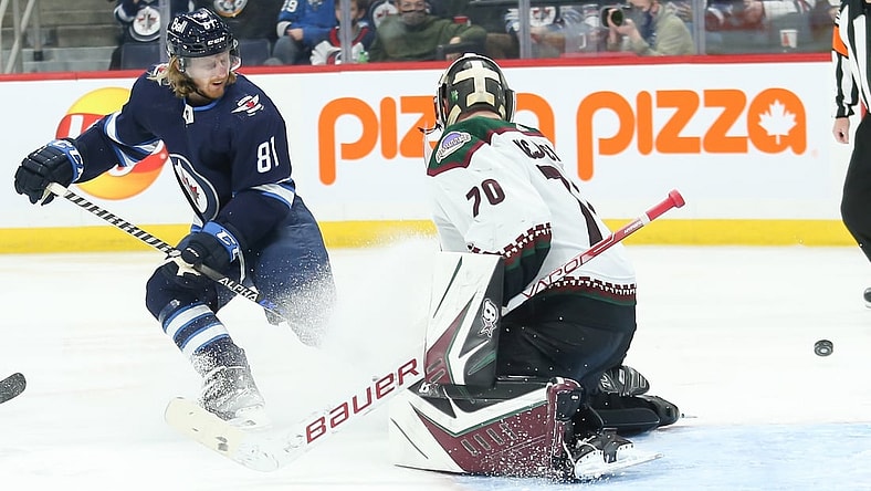 Nov 29, 2021; Winnipeg, Manitoba, CAN;  Winnipeg Jets forward Kyle Connor (81) watches the puck go past Arizona Coyotes goalie Kyle Capobianco (70) during the second period at Canada Life Centre. Mandatory Credit: Terrence Lee-USA TODAY Sports