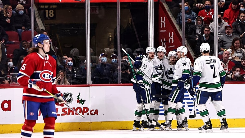 Nov 29, 2021; Montreal, Quebec, CAN; Vancouver Canucks right wing Conor Garland (8) celebrates his goal against Montreal Canadiens with teammates during the second period at Bell Centre. Mandatory Credit: Jean-Yves Ahern-USA TODAY Sports