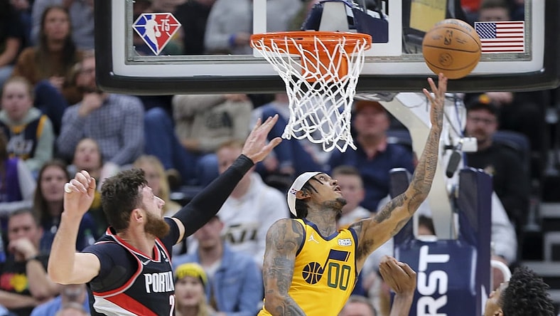 Nov 29, 2021; Salt Lake City, Utah, USA; Utah Jazz guard Jordan Clarkson (00) is fouled by Portland Trail Blazers center Jusuf Nurkic (27) as he attempts a layup during the second quarter at Vivint Arena. Mandatory Credit: Rob Gray-USA TODAY Sports