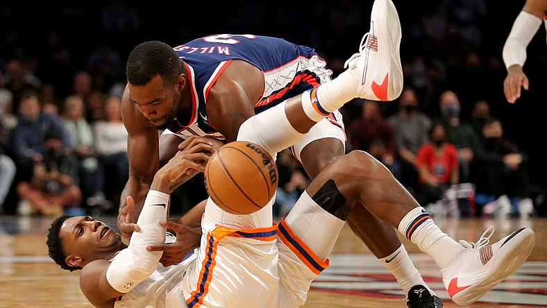 Nov 30, 2021; Brooklyn, New York, USA; New York Knicks guard RJ Barrett (9) and Brooklyn Nets forward Paul Millsap (31) fight for possession during the second quarter at Barclays Center. Mandatory Credit: Brad Penner-USA TODAY Sports