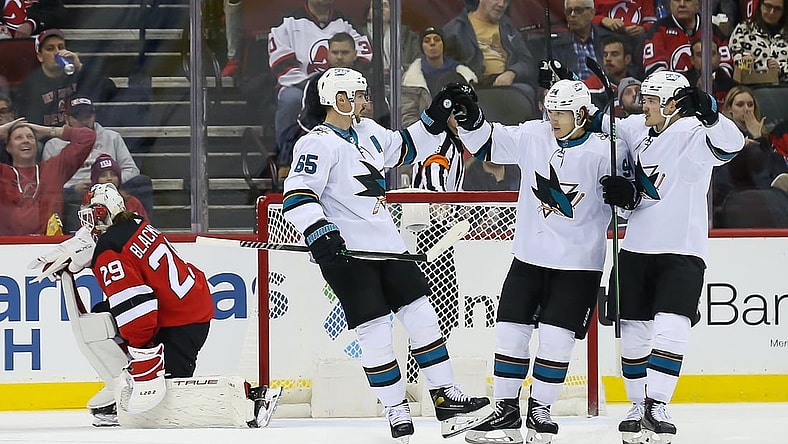 Nov 30, 2021; Newark, New Jersey, USA; San Jose Sharks defenseman Erik Karlsson (65) celebrates with left wing Alexander Barabanov (94) and left wing Rudolfs Balcers (92) after scoring a goal against New Jersey Devils during the second period at Prudential Center. Mandatory Credit: Tom Horak-USA TODAY Sports