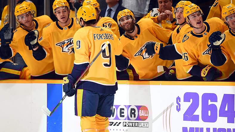 Nov 30, 2021; Nashville, Tennessee, USA; Nashville Predators left wing Filip Forsberg (9) is congratulated by teammates after a goal during the first period against the Columbus Blue Jackets at Bridgestone Arena. Mandatory Credit: Christopher Hanewinckel-USA TODAY Sports