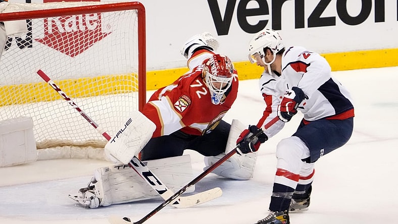 Nov 30, 2021; Sunrise, Florida, USA; Washington Capitals center Nic Dowd (26) takes a shot on Florida Panthers goaltender Sergei Bobrovsky (72) during the second period at FLA Live Arena. Mandatory Credit: Jasen Vinlove-USA TODAY Sports