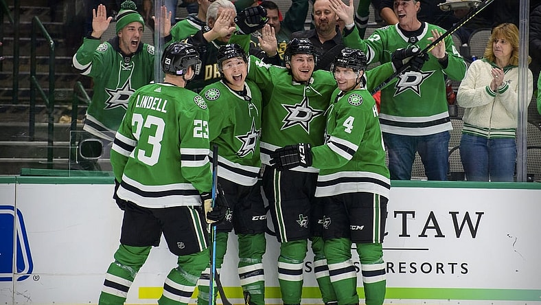 Nov 30, 2021; Dallas, Texas, USA; Dallas Stars defenseman Esa Lindell (23) and left wing Jason Robertson (21) and left wing Roope Hintz (24) and defenseman Miro Heiskanen (4) celebrates a second goal scored by Hintz against the Carolina Hurricanes during the second period at the American Airlines Center. Mandatory Credit: Jerome Miron-USA TODAY Sports
