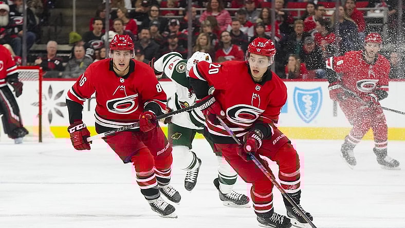 Dec 7, 2019; Raleigh, NC, USA;  Carolina Hurricanes center Sebastian Aho (20) skates up the ice with the puck with left wing Teuvo Teravainen (86) against the Minnesota Wild at PNC Arena. The Carolina Hurricanes defeated the Minnesota Wild 6-2. Mandatory Credit: James Guillory-USA TODAY Sports