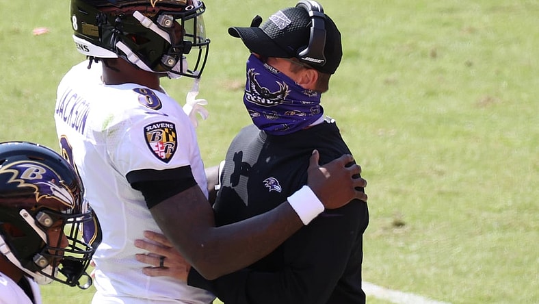 Oct 4, 2020; Landover, Maryland, USA; Baltimore Ravens quarterback Lamar Jackson (8) hugs Ravens head coach John Harbaugh (R) after scoring a touchdown against the Washington Football Team at FedExField. Mandatory Credit: Geoff Burke-USA TODAY Sports