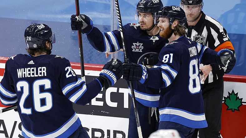 May 14, 2021; Winnipeg, Manitoba, CAN; Winnipeg Jets left wing Kyle Connor (81) celebrates his goal against the Toronto Maple Leafs with right wing Blake Wheeler (26) and center Mark Scheifele (55) during the second period at Bell MTS Place. Mandatory Credit: James Carey Lauder-USA TODAY Sports