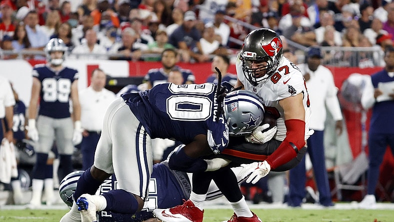 Sep 9, 2021; Tampa, Florida, USA; Tampa Bay Buccaneers tight end Rob Gronkowski (87) catches the ball against Dallas Cowboys defensive end DeMarcus Lawrence (90) during the first half at Raymond James Stadium. Mandatory Credit: Kim Klement-USA TODAY Sports