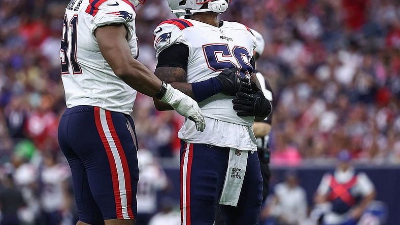 Oct 10, 2021; Houston, Texas, USA; New England Patriots inside linebacker Jamie Collins (58) reacts with defensive end Deatrich Wise (91) after getting a sack during the fourth quarter against the Houston Texans at NRG Stadium. Mandatory Credit: Troy Taormina-USA TODAY Sports