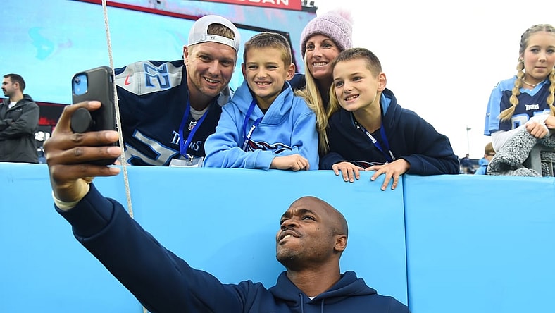 Nov 21, 2021; Nashville, Tennessee, USA; Tennessee Titans running back Adrian Peterson (8) takes a selfie with fans before the game against the Houston Texans at Nissan Stadium. Mandatory Credit: Christopher Hanewinckel-USA TODAY Sports