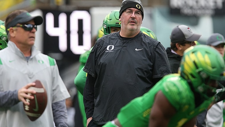 Oregon offensive coordinator Joe Moorhead, center, keeps an eye on warmups before the game against Oregon State.

Eug 112821 Morehead 01
