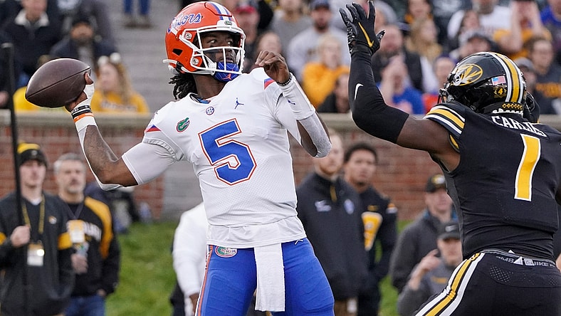 Nov 20, 2021; Columbia, Missouri, USA; Florida Gators quarterback Emory Jones (5) throws a pass as Missouri Tigers defensive back Jaylon Carlies (1) defends during the game at Faurot Field at Memorial Stadium. Mandatory Credit: Denny Medley-USA TODAY Sports