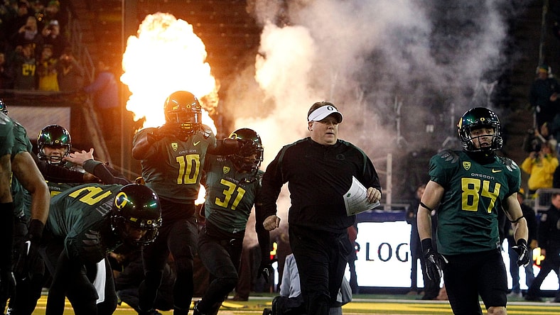 Head Coach Chip Kelly, center, and the team take the field for the first Pac-12 Championship game at Autzen in 2011.

Eug 113021 Pac12 Champs 01