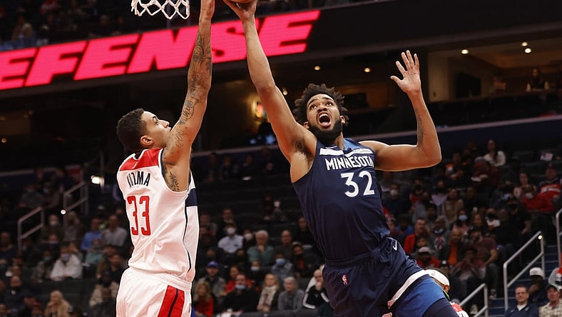Dec 1, 2021; Washington, District of Columbia, USA; Minnesota Timberwolves center Karl-Anthony Towns (32) shoots the ball as Washington Wizards forward Kyle Kuzma (33) defends during the first quarter at Capital One Arena. Mandatory Credit: Geoff Burke-USA TODAY Sports