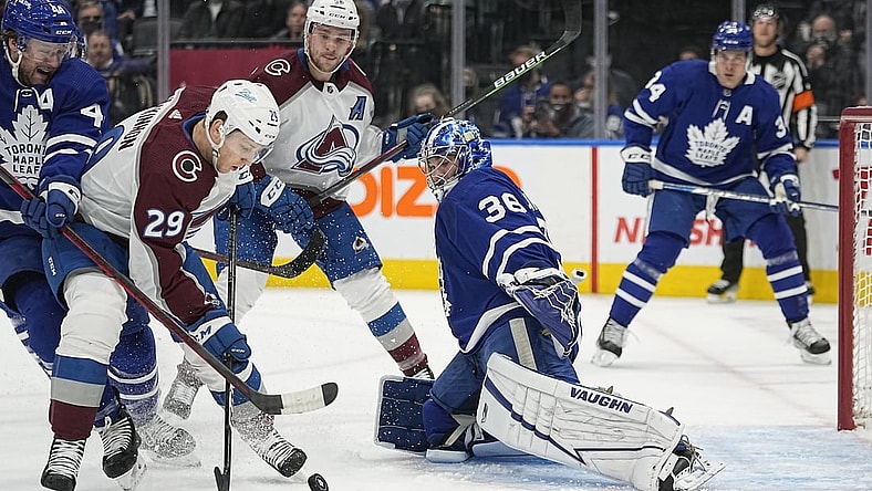 Dec 1, 2021; Toronto, Ontario, CAN; Colorado Avalanche forward Nathan MacKinnon (29) tries to get a shot off against Toronto Maple Leafs goaltender Jack Campbell (36) as Toronto Maple Leafs defenseman Morgan Rielly (44) helps out during the first period at Scotiabank Arena. Mandatory Credit: John E. Sokolowski-USA TODAY Sports