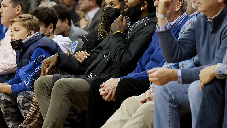 Dec 1, 2021; Newark, New Jersey, USA; Brooklyn Nets guard Kyrie Irving (center, black hat) watches action during the second half of the game between the Seton Hall Pirates and the Wagner Seahawks at Prudential Center. Mandatory Credit: Vincent Carchietta-USA TODAY Sports