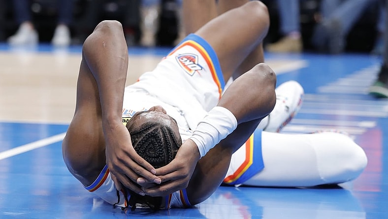 Dec 1, 2021; Oklahoma City, Oklahoma, USA; Oklahoma City Thunder guard Shai Gilgeous-Alexander (2) grabs his head after hitting the floor following a foul during the second half against the Houston Rockets at Paycom Center. Mandatory Credit: Alonzo Adams-USA TODAY Sports