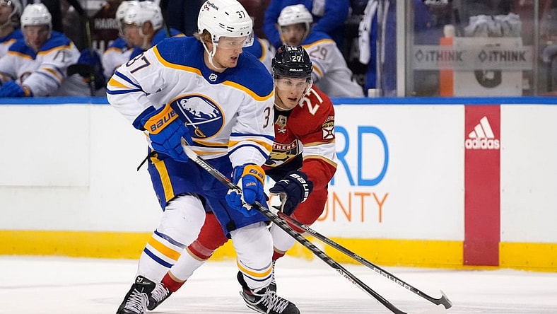 Dec 2, 2021; Sunrise, Florida, USA; Buffalo Sabres center Casey Mittelstadt (37) controls the puck away from Florida Panthers center Eetu Luostarinen (27) during the first period at FLA Live Arena. Mandatory Credit: Jasen Vinlove-USA TODAY Sports