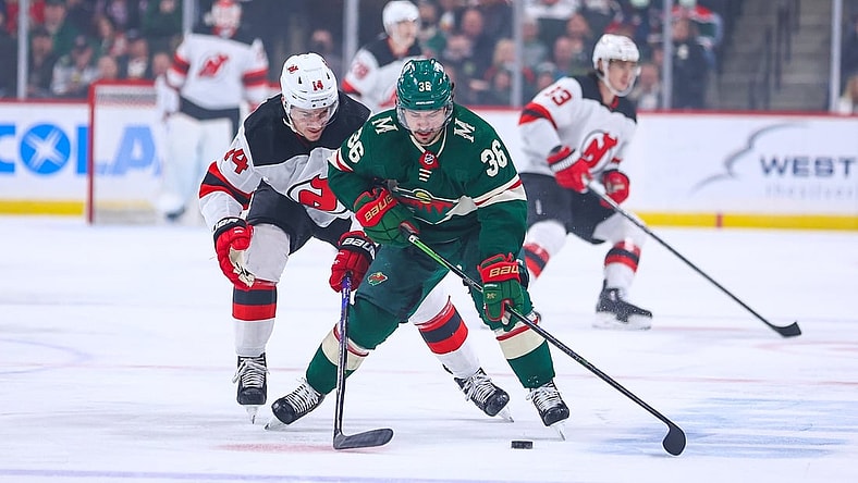 Dec 2, 2021; Saint Paul, Minnesota, USA; Minnesota Wild right wing Mats Zuccarello (36) and New Jersey Devils right wing Nathan Bastian (14) fight for the puck during the first period at Xcel Energy Center. Mandatory Credit: Harrison Barden-USA TODAY Sports