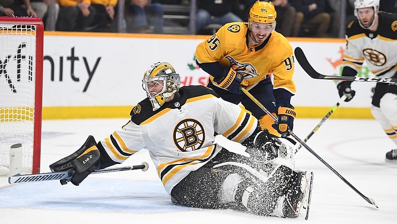 Dec 2, 2021; Nashville, Tennessee, USA; Boston Bruins goaltender Jeremy Swayman (1) looks behind him for the puck after a save on a play by Nashville Predators center Matt Duchene (95) during the third period at Bridgestone Arena. Mandatory Credit: Christopher Hanewinckel-USA TODAY Sports