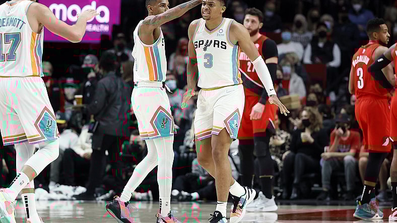 Dec 2, 2021; Portland, Oregon, USA; cSan Antonio Spurs small forward Keldon Johnson (3) celebrates a basket and a foul with teammate Dejounte Murray (5) during the first half against the Portland Trail Blazers at Moda Center. Mandatory Credit: Soobum Im-USA TODAY Sports