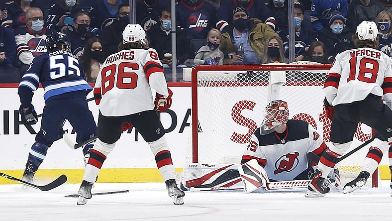Dec 3, 2021; Winnipeg, Manitoba, CAN; Winnipeg Jets center Mark Scheifele (55) scores on New Jersey Devils goaltender Jonathan Bernier (45) in the first period at Canada Life Centre. Mandatory Credit: James Carey Lauder-USA TODAY Sports
