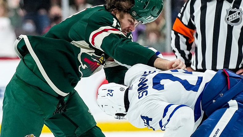 Dec 4, 2021; Saint Paul, Minnesota, USA; Minnesota Wild forward Marcus Foligno (17) fights Toronto Maple Leafs forward Wayne Simmonds (24) during the first period at Xcel Energy Center. Mandatory Credit: Brace Hemmelgarn-USA TODAY Sports
