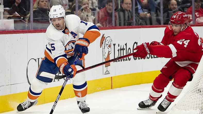 Dec 4, 2021; Detroit, Michigan, USA; New York Islanders right wing Cal Clutterbuck (15) skates with the puck against Detroit Red Wings center Pius Suter (24) during the first period at Little Caesars Arena. Mandatory Credit: Raj Mehta-USA TODAY Sports