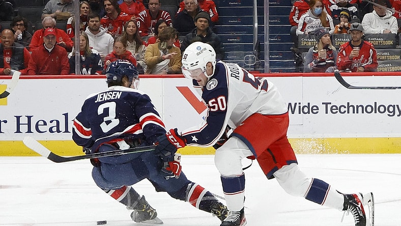 Dec 4, 2021; Washington, District of Columbia, USA; Columbus Blue Jackets left wing Eric Robinson (50) skates with the puck around Washington Capitals defenseman Nick Jensen (3) during the second period at Capital One Arena. Mandatory Credit: Geoff Burke-USA TODAY Sports