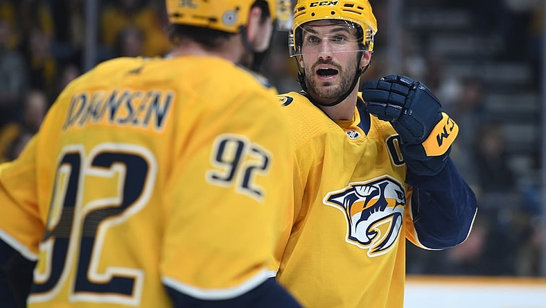 Dec 4, 2021; Nashville, Tennessee, USA; Nashville Predators defenseman Roman Josi (59) talks positioning with center Ryan Johansen (92) on a face off in overtime against the Montreal Canadiens at Bridgestone Arena. Mandatory Credit: Christopher Hanewinckel-USA TODAY Sports