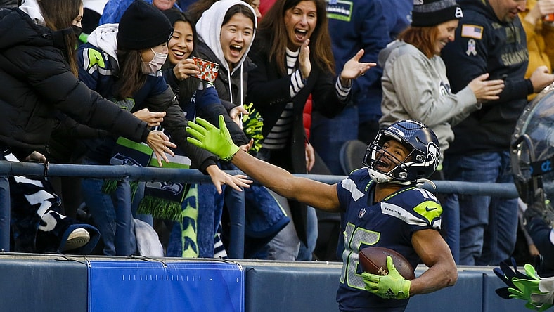 Dec 5, 2021; Seattle, Washington, USA; Seattle Seahawks wide receiver Tyler Lockett (16) celebrates with fans after catching a touchdown pass against the San Francisco 49ers during the third quarter at Lumen Field. Mandatory Credit: Joe Nicholson-USA TODAY Sports