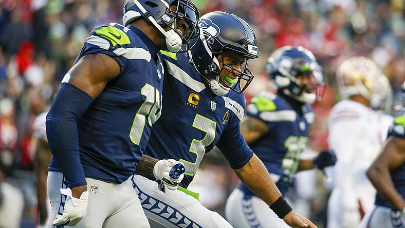Dec 5, 2021; Seattle, Washington, USA; Seattle Seahawks quarterback Russell Wilson (3) celebrates with wide receiver DK Metcalf (14) after throwing a touchdown pass against the San Francisco 49ers during the third quarter at Lumen Field. Mandatory Credit: Joe Nicholson-USA TODAY Sports