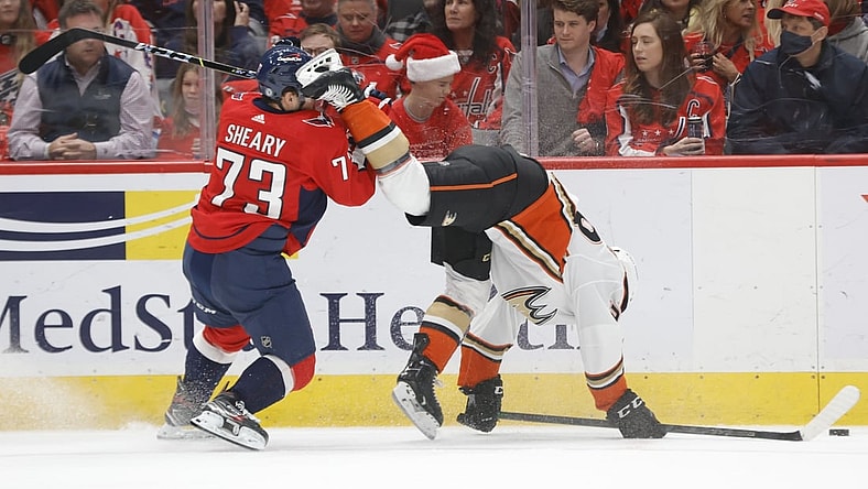 Dec 6, 2021; Washington, District of Columbia, USA; Washington Capitals left wing Conor Sheary (73) checks Anaheim Ducks right wing Vinni Lettieri (28) during the first period at Capital One Arena. Mandatory Credit: Geoff Burke-USA TODAY Sports