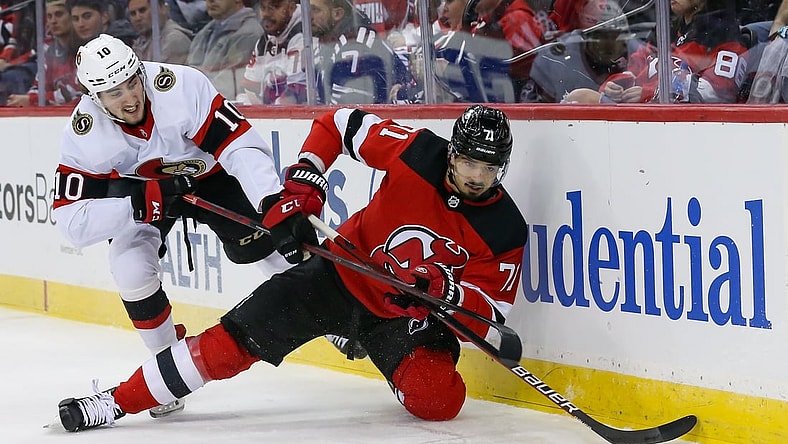 Dec 6, 2021; Newark, New Jersey, USA; New Jersey Devils defenseman Jonas Siegenthaler (71) moves the puck past Ottawa Senators left wing Alex Formenton (10) during the first period at Prudential Center. Mandatory Credit: Tom Horak-USA TODAY Sports