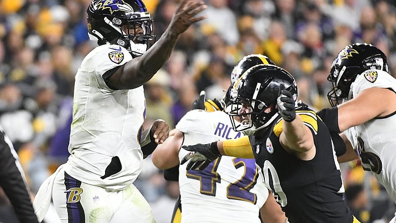 Dec 5, 2021; Pittsburgh, Pennsylvania, USA;  Baltimore Ravens quarterback Lamar Jackson (8) is pressured by linebacker T.J. Watt (90) during the second quarter at Heinz Field. Mandatory Credit: Philip G. Pavely-USA TODAY Sports