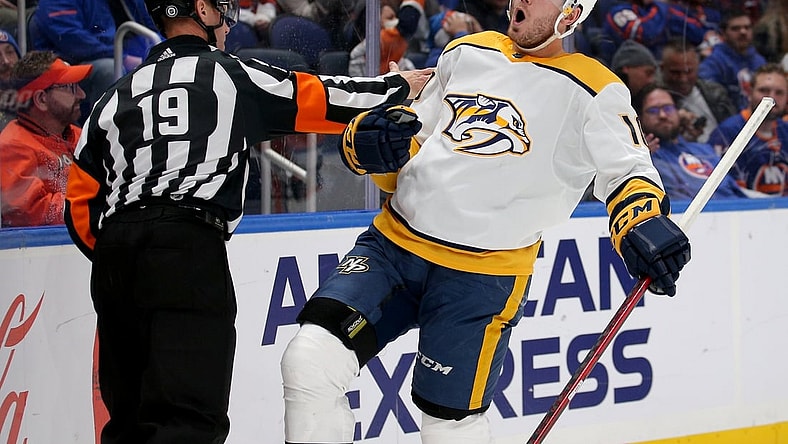Dec 9, 2021; Elmont, New York, USA; Nashville Predators center Colton Sissons (10) celebrates his goal against the New York Islanders in front of referee Gord Dwyer (19) during the first period at UBS Arena. Mandatory Credit: Brad Penner-USA TODAY Sports