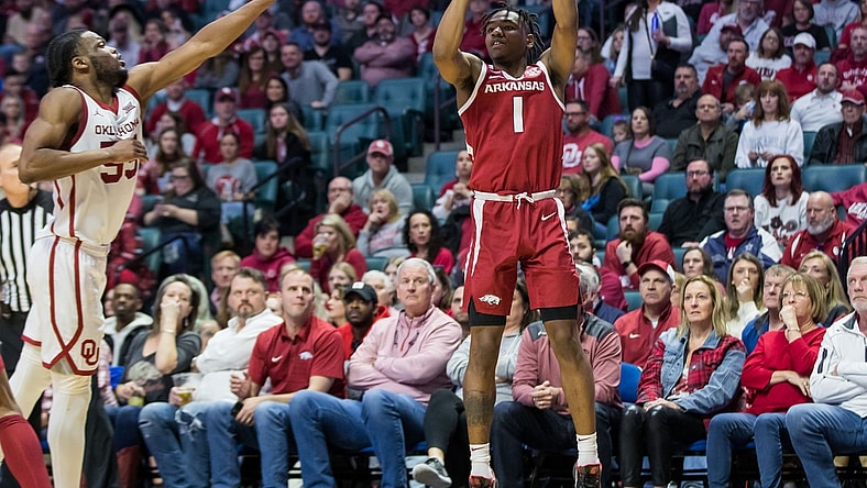 Dec 11, 2021; Tulsa, Oklahoma, USA;  Arkansas Razorbacks guard JD Notae (1) shoots the ball as Oklahoma Sooners guard Elijah Harkless (55) tries to block it during the second half at BOK Center. Oklahoma won 88-66. Mandatory Credit: Brett Rojo-USA TODAY Sports