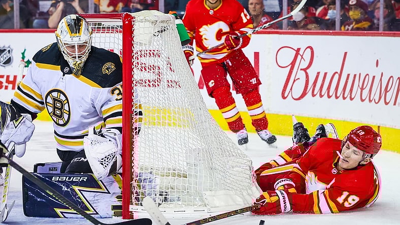 Dec 11, 2021; Calgary, Alberta, CAN; Calgary Flames left wing Matthew Tkachuk (19) reach for the puck in front of Boston Bruins goaltender Linus Ullmark (35) during the first period at Scotiabank Saddledome. Mandatory Credit: Sergei Belski-USA TODAY Sports