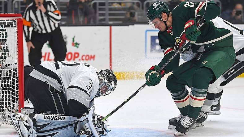 Dec 11, 2021; Los Angeles, California, USA;  Los Angeles Kings goaltender Jonathan Quick (32) blocks the puck as Minnesota Wild center Nick Bjugstad (27) tried to poke it under his glove in the first period of the game at Staples Center. Mandatory Credit: Jayne Kamin-Oncea-USA TODAY Sports