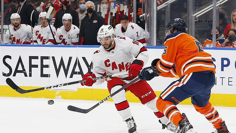 Dec 11, 2021; Edmonton, Alberta, CAN; Carolina Hurricanes forward Vincent Trocheck (16) and Edmonton Oilers defensemen Cody Ceci (5) battle for a loose puck during the second period at Rogers Place. Mandatory Credit: Perry Nelson-USA TODAY Sports
