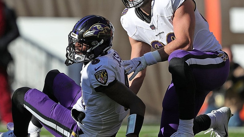 Baltimore Ravens quarterback Lamar Jackson (8) sits on the ground after an injury during the first half of an NFL football game at FirstEnergy Stadium, Sunday, Dec. 12, 2021, in Cleveland, Ohio. [Jeff Lange/Beacon Journal]

Browns 3