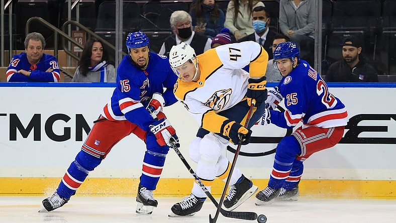 Dec 12, 2021; New York, New York, USA; Nashville Predators right wing Michael McCarron (47) fights for the puck with New York Rangers right wing Ryan Reaves (75) and New York Rangers defenseman Libor Hajek (25) during the second period at Madison Square Garden. Mandatory Credit: Danny Wild-USA TODAY Sports