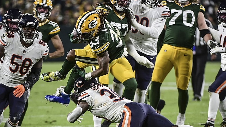 Dec 12, 2021; Green Bay, Wisconsin, USA; Green Bay Packers running back Aaron Jones (33) is tackled by Chicago Bears linebacker Trevis Gipson (99) in the second quarter at Lambeau Field. Mandatory Credit: Benny Sieu-USA TODAY Sports
