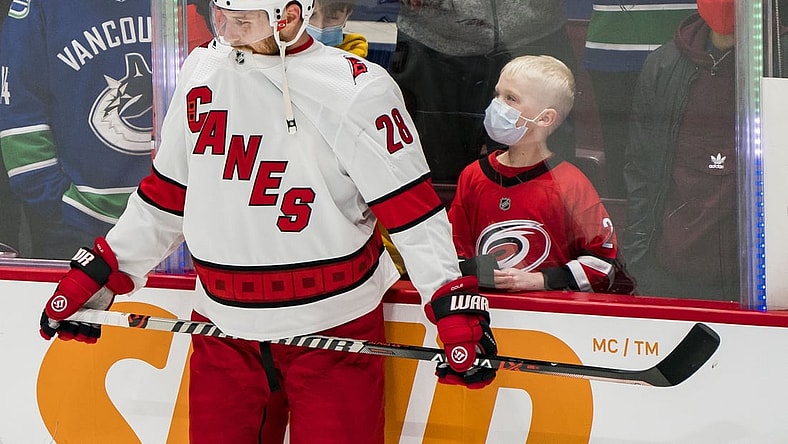Dec 12, 2021; Vancouver, British Columbia, CAN;  A young fan reacts after seeing Carolina Hurricanes defenseman Ian Cole (28) up close prior to the start of a game against the Vancouver Canucks at Rogers Arena. Mandatory Credit: Bob Frid-USA TODAY Sports