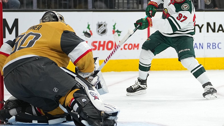 Dec 12, 2021; Las Vegas, Nevada, USA;  Minnesota Wild left wing Kirill Kaprizov (97) shoots toward Vegas Golden Knights goaltender Robin Lehner (90) during the second period at T-Mobile Arena. Mandatory Credit: Stephen R. Sylvanie-USA TODAY Sports