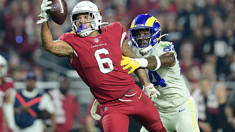 Dec 13, 2021; Glendale, Arizona, USA; Arizona Cardinals running back James Conner (6) makes a catch against Los Angeles Rams outside linebacker Leonard Floyd (54) during the first half at State Farm Stadium. Mandatory Credit: Joe Camporeale-USA TODAY Sports
