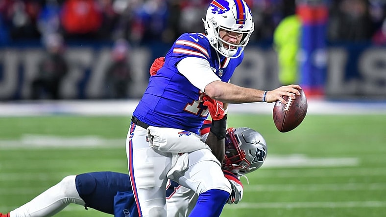 Dec 6, 2021; Orchard Park, New York, USA; Buffalo Bills quarterback Josh Allen (17) and New England Patriots outside linebacker Matt Judon (9) in the third quarter at Highmark Stadium. Mandatory Credit: Mark Konezny-USA TODAY Sports