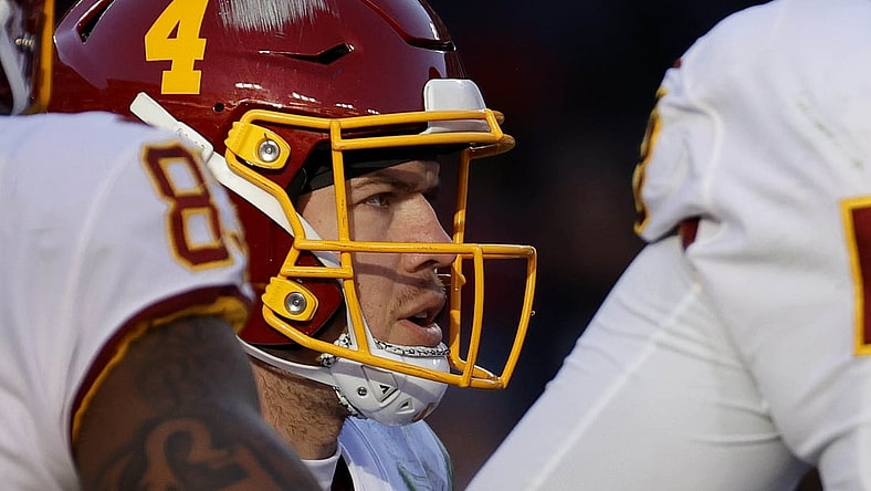 Dec 12, 2021; Landover, Maryland, USA; Washington Football Team quarterback Taylor Heinicke (4) stands in the huddle against the Dallas Cowboys at FedExField. Mandatory Credit: Geoff Burke-USA TODAY Sports