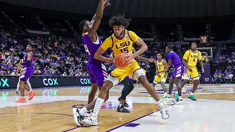 Dec 14, 2021; Baton Rouge, Louisiana, USA;  LSU Tigers center Efton Reid (15) dribbles against Northwestern State Demons center Kendal Coleman (4) during the first half at Pete Maravich Assembly Center. Mandatory Credit: Stephen Lew-USA TODAY Sports